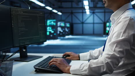 Close-up-of-expert-typing-on-keyboard-in-server-room,-coding-on-computer