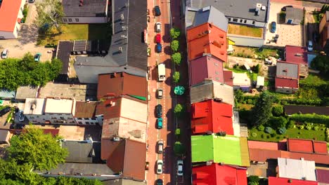 top aerial panoramic view of lowicz old town historical city centre with rynek market square, old town hall, new city hall, colorful buildings with multicolored facade and tiled roofs, poland