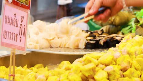 street food stall with dim sum and steamed buns