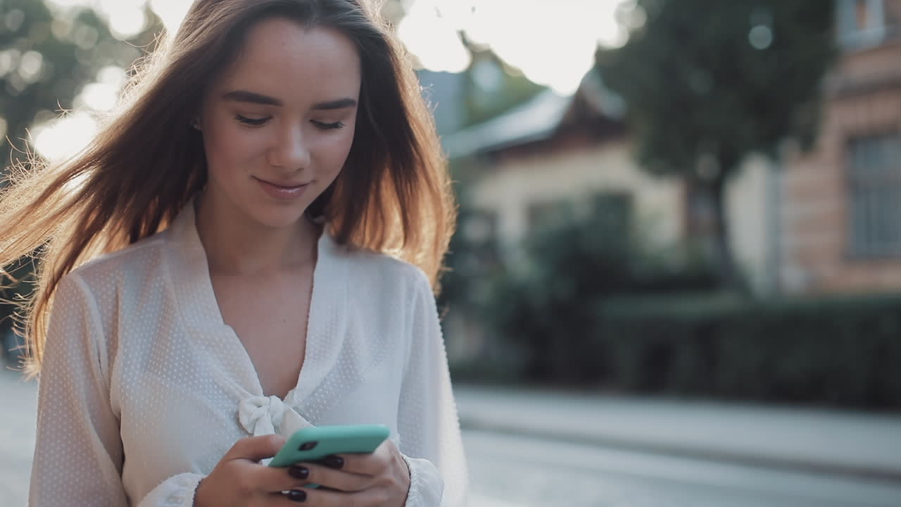 Young woman using a mobile phone on the street