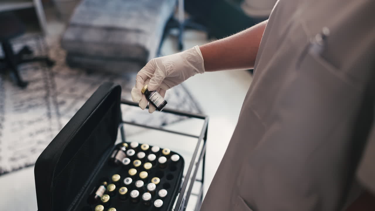 Gloved Hands Holding a Small Medical Vial in a Clinic
