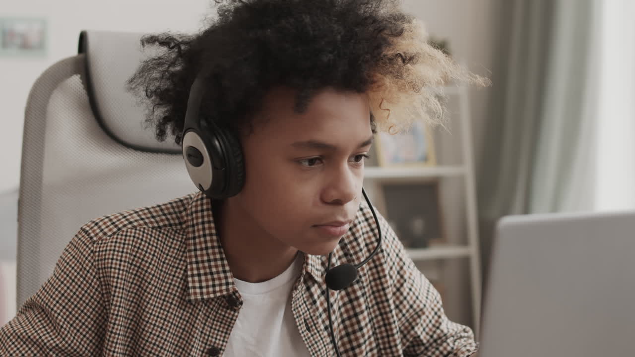 Teenage Gamer Talking on Headset Microphone