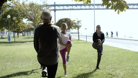 mature men and women stretching and enjoying outdoors