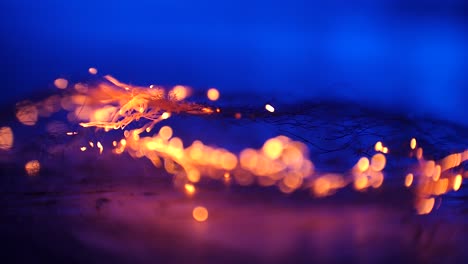 macro of steel wool getting burned from right to left on blue background