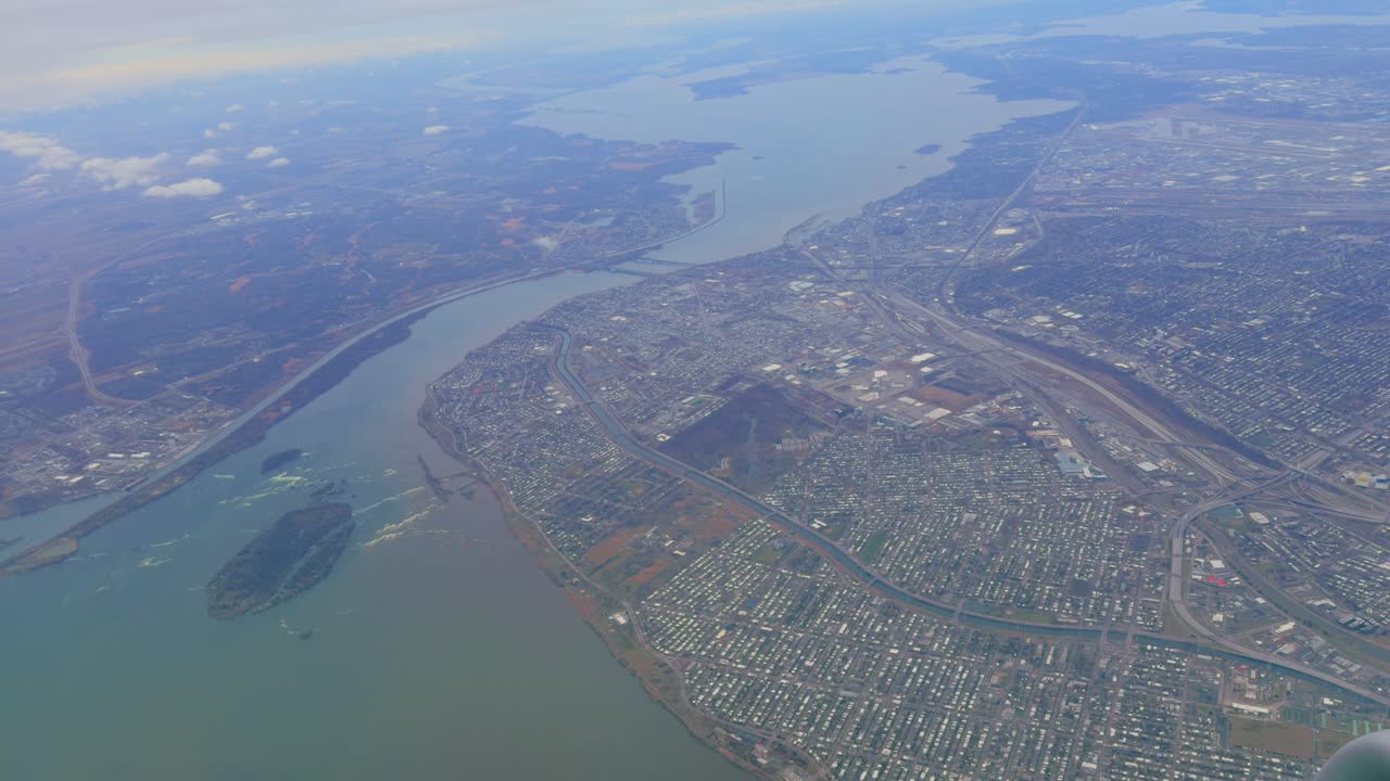 Aerial view of North America city by river covered by clouds