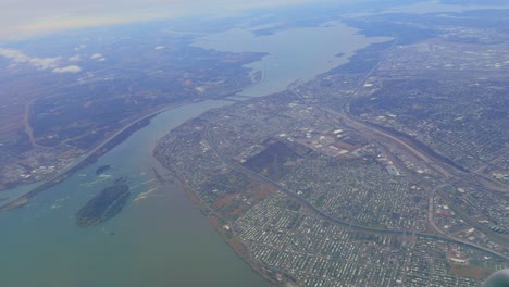 aerial view of north america city by river covered by clouds