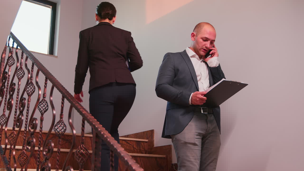 Stressed company manager talking on smartphone
