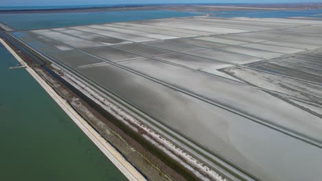 salt areas filled with seawater on rectangle pools evaporating for production of salt on seaside of albania