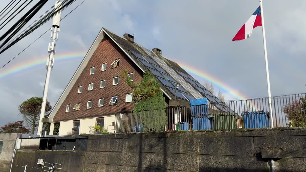 Southern chilean city embellished by a lovely rainbow
