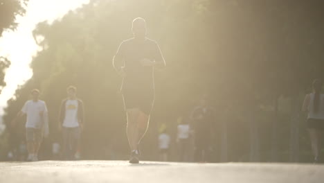 people running in a park at sunrise