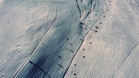 above chairlift and downhill ski slope in austria, aerial