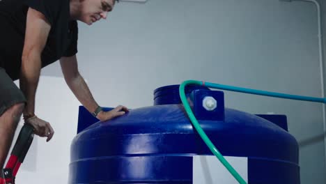 man filling a water tank