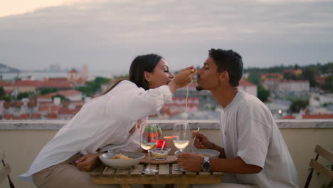 positive lovers eating balcony closeup. couple celebrating anniversary vertical