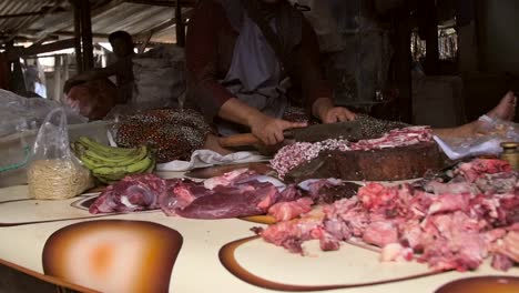 panning along a market stall of meat