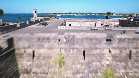 drone shot low over the castillo de san marcos, in sunny st