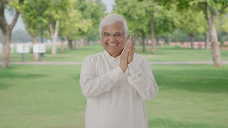 Happy-Indian-old-man-clapping-and-appreciating-someone-in-park