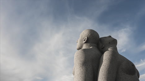 Granite-Sculpture-Of-A-Man-And-Woman-Sitting-Back-to-Back-At-Vigeland-Park-In-Frogner-Park,-Oslo,-Norway