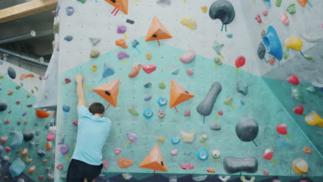 man rock climbing on a bouldering wall