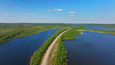 drone shot of a road in middle of ponds in kaldoaivi wilderness, summer in lapland