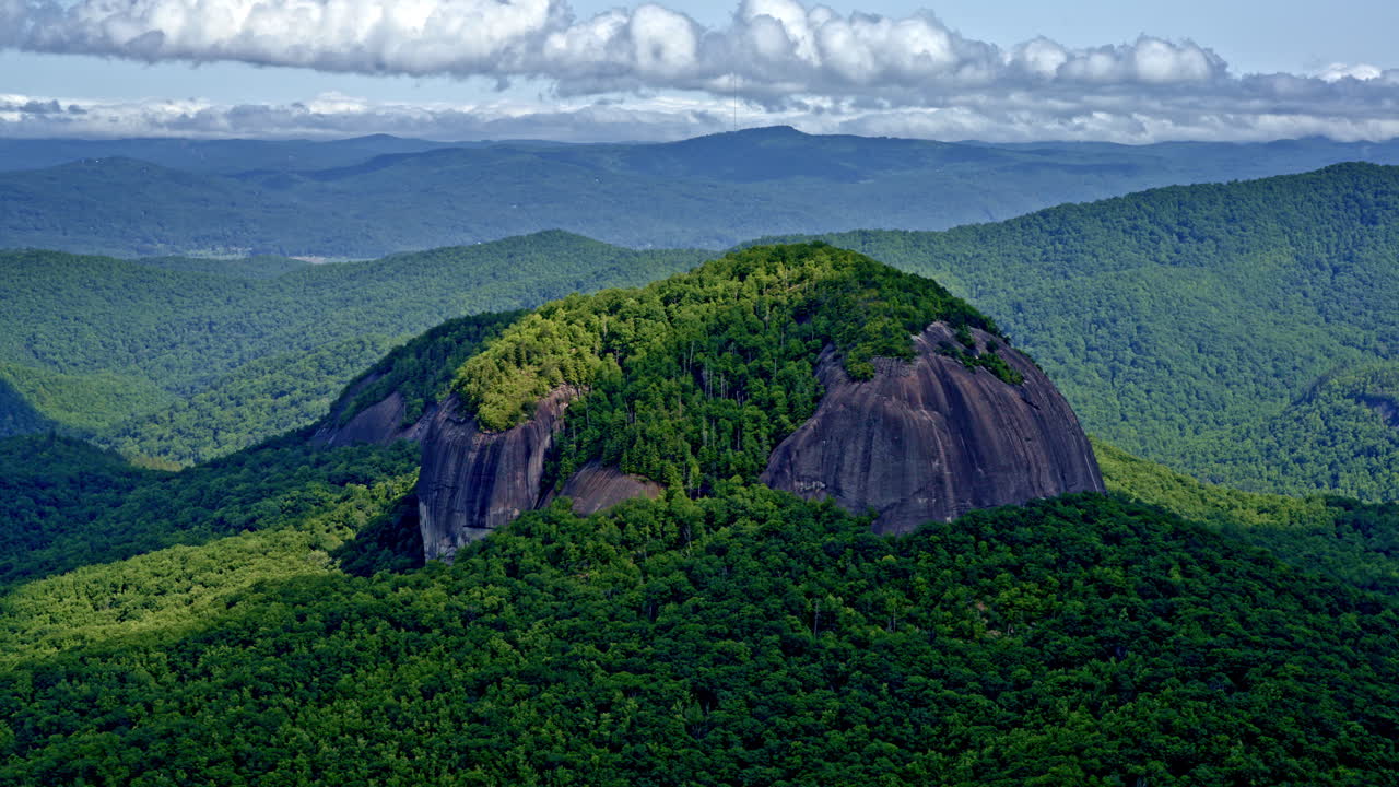 Cinematic aerial footage of a single dominant mountain set apart from its neighbors