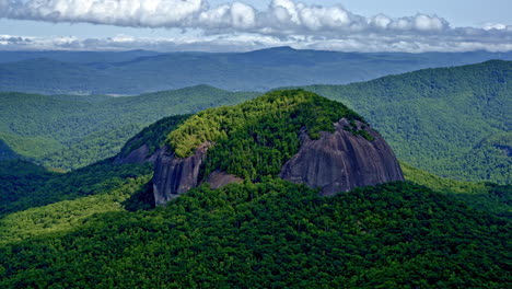 cinematic aerial footage of a single dominant mountain set apart from its neighbors