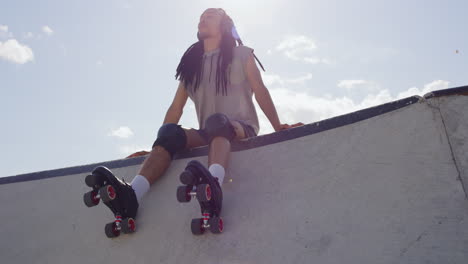 one mixed race man with long dreadlocks wearing