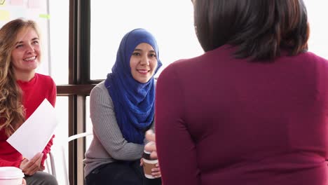 international diverse women sitting together talking and sharing in group meeting