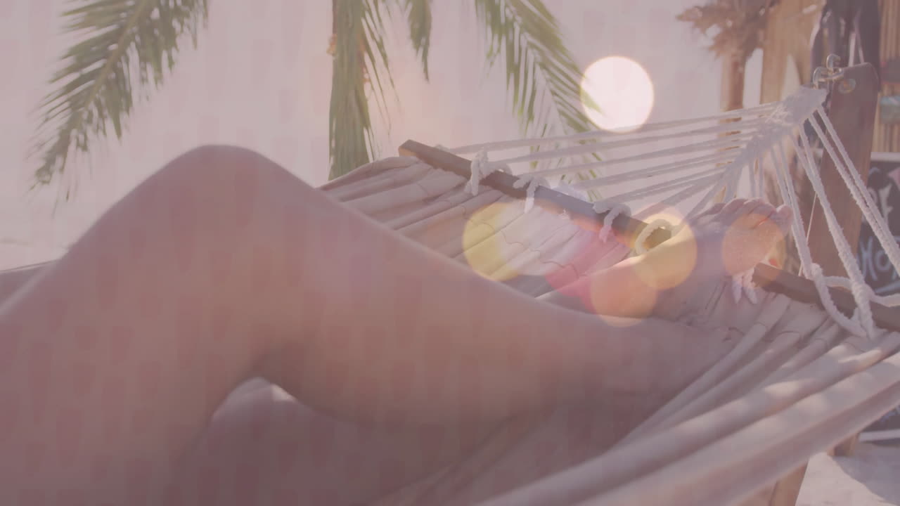 Marketer designing health ad using hammock footage with animated chart and palm frond icons