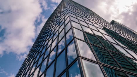 modern skyscraper facade with cloud reflections