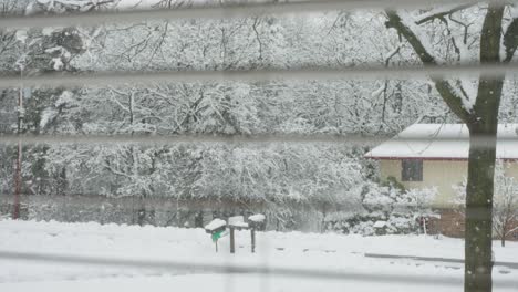 viewing-a-snowstorm-out-of-a-window-with-the-window-frame-in-the-shot