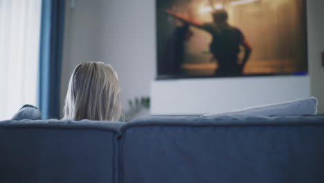 woman relaxing on couch watching tv