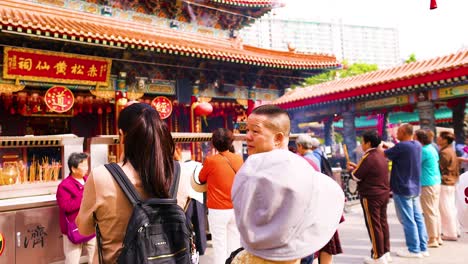 people engaging in rituals at hong kong temple