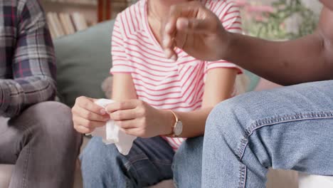 midsection of diverse friends holding hands at group therapy, slow motion