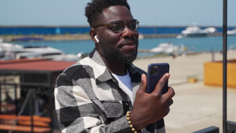 man video chatting at the waterfront