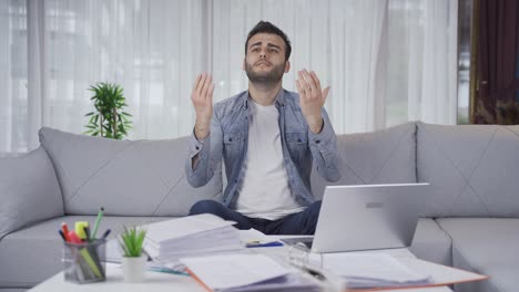 young businessman praying while doing business.