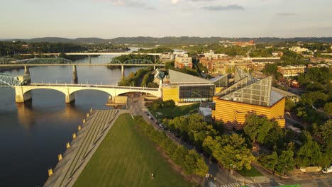 Chattanooga-aquarium-and-bridges-over-river,-dusk-time,-aerial-orbit-view