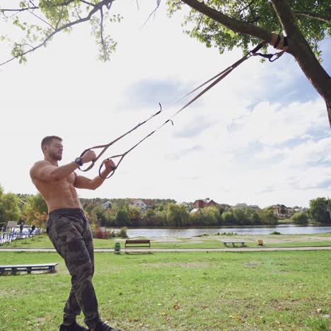 . shirtless male exercise outdoors. muscular athlete exercising push up outside