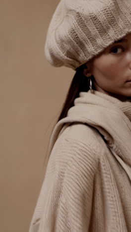 stylish woman in cozy beige knitwear and accessories