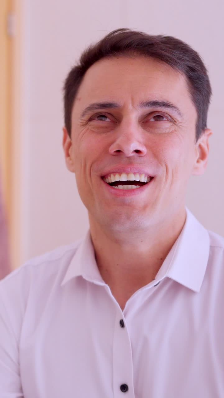 Optimistic businessman motivating himself in bathroom mirror