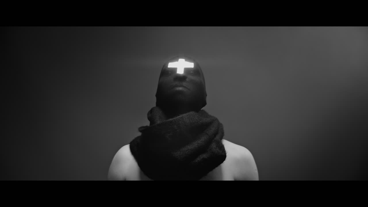 Masked man with cross of light glowing on his face rise head up