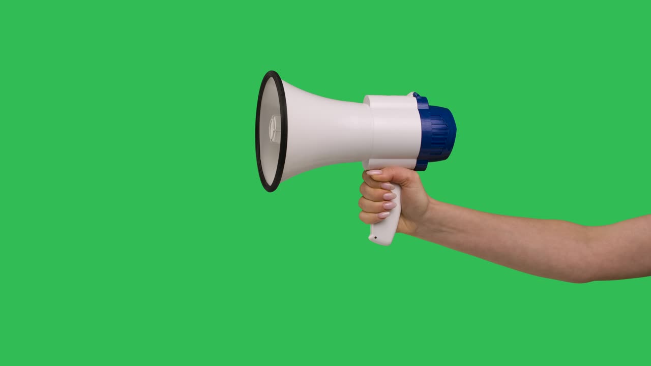 Female hand with megaphone on green screen chroma key background close up. Great for advertising and promotion, attention and message. Slow motion
