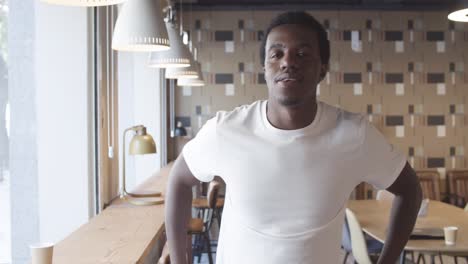 handsome african american young man standing and posing