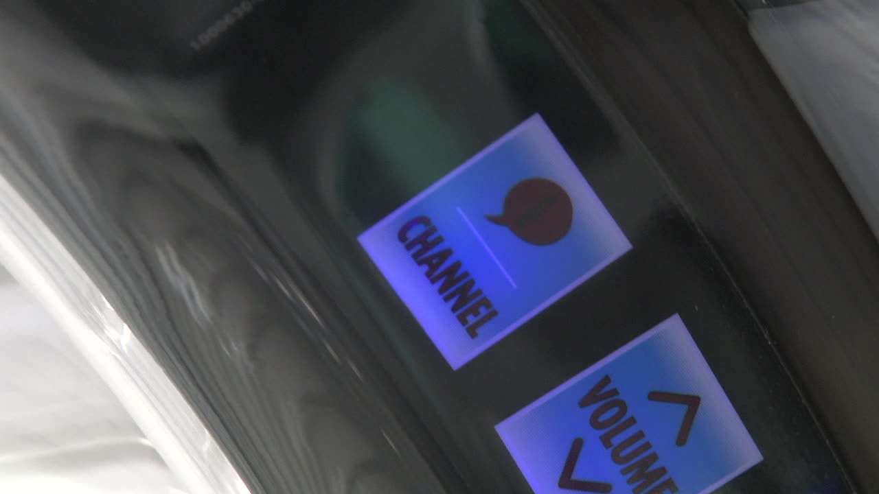 Panning shot across tanning bed control buttons and LCD display screen