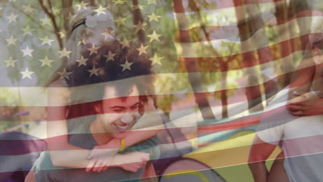 Friends having outdoor picnic with American flag animation overlay, smiling together
