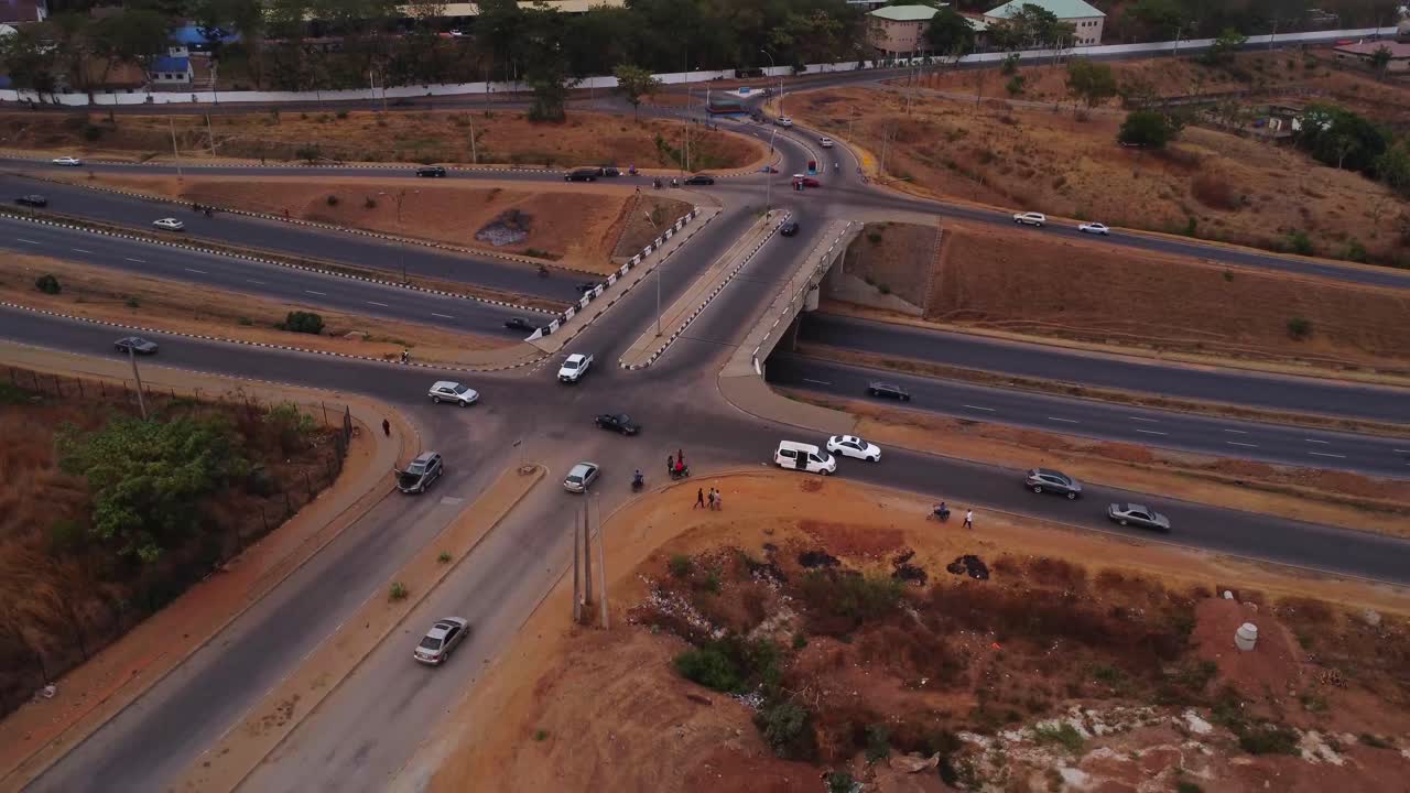 Jib down of a busy intersection alongside a highway in Abuja, Nigeria