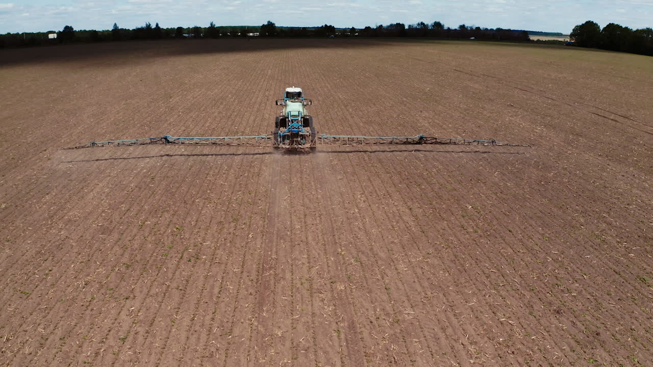 Tractor vehicles working at field. Aerial shots of the tractor while working in the field