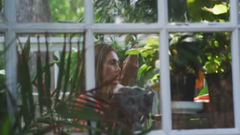 woman gardening in a greenhouse