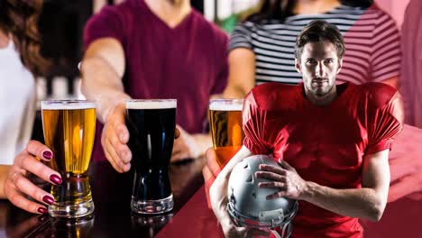 Animation-of-male-american-football-player-over-male-and-female-friends-holding-beers-at-bar