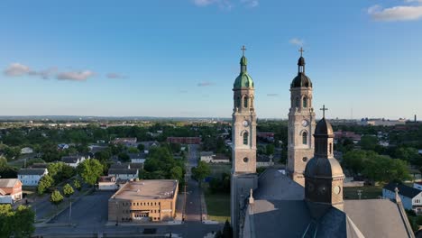 an aerial view of the saint stanislaus b and m roman catholic church spires in buffalo, new york in the light of the setting sun