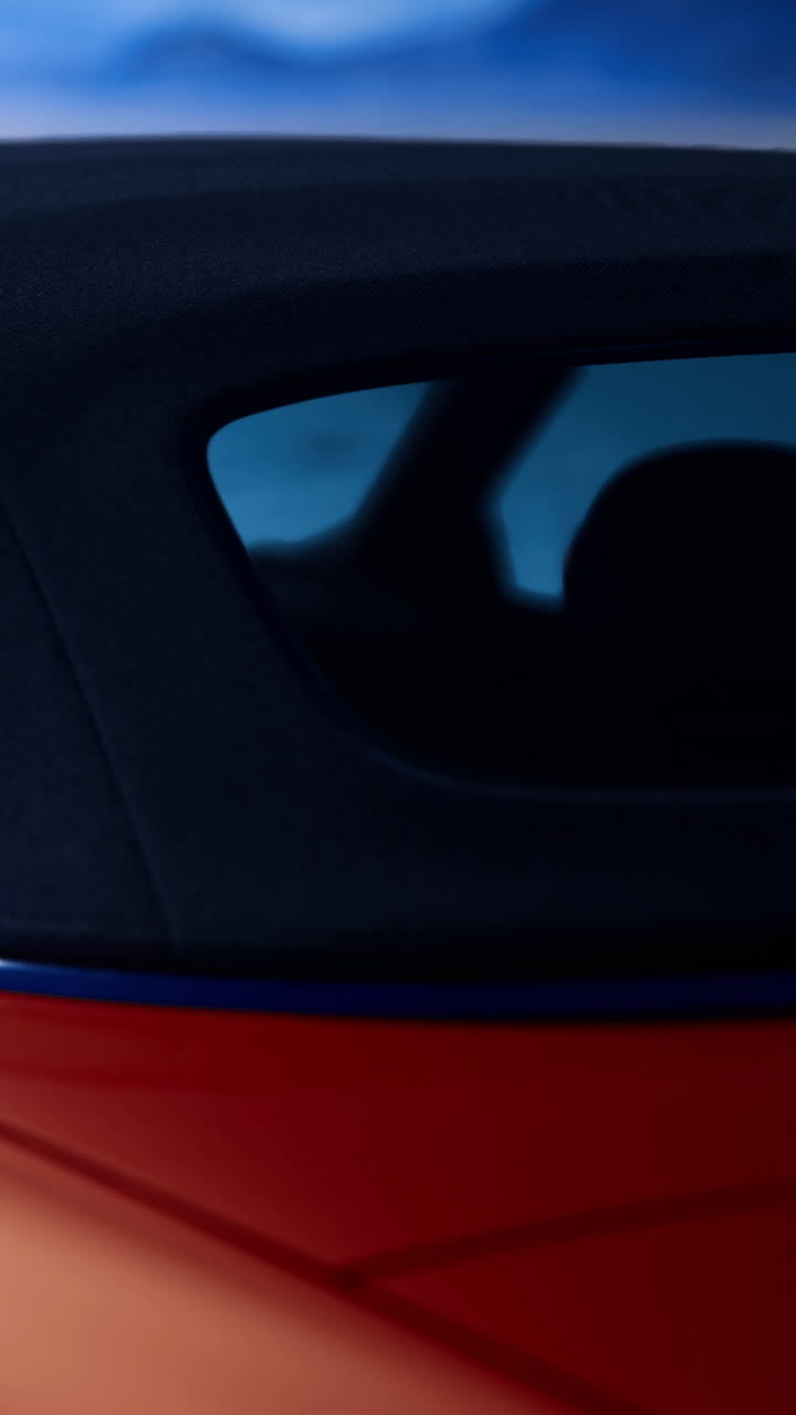 Bright red sports car captures attention against a vibrant blue background